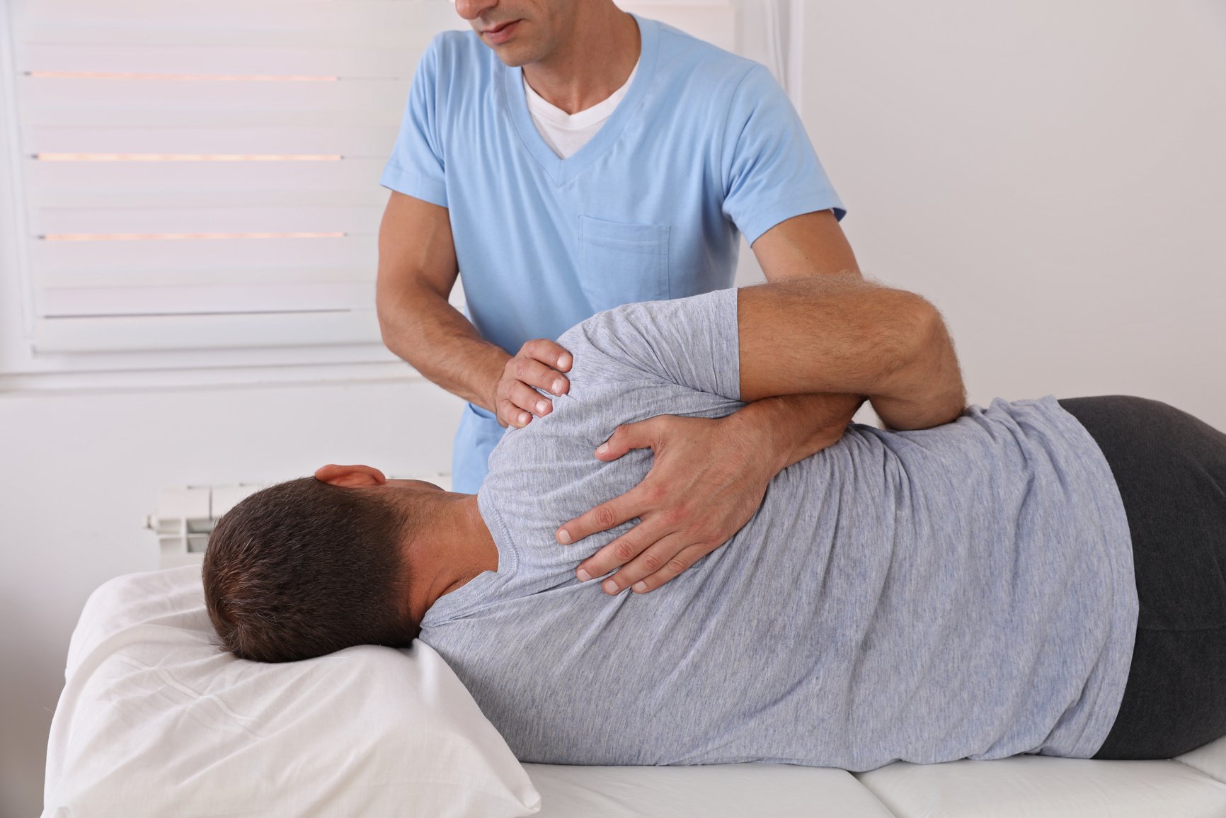 Back pain , Physiotherapy. Man Chiropractic pain relief adjustment /Kinesiology treatment . Osteopathy practitioner